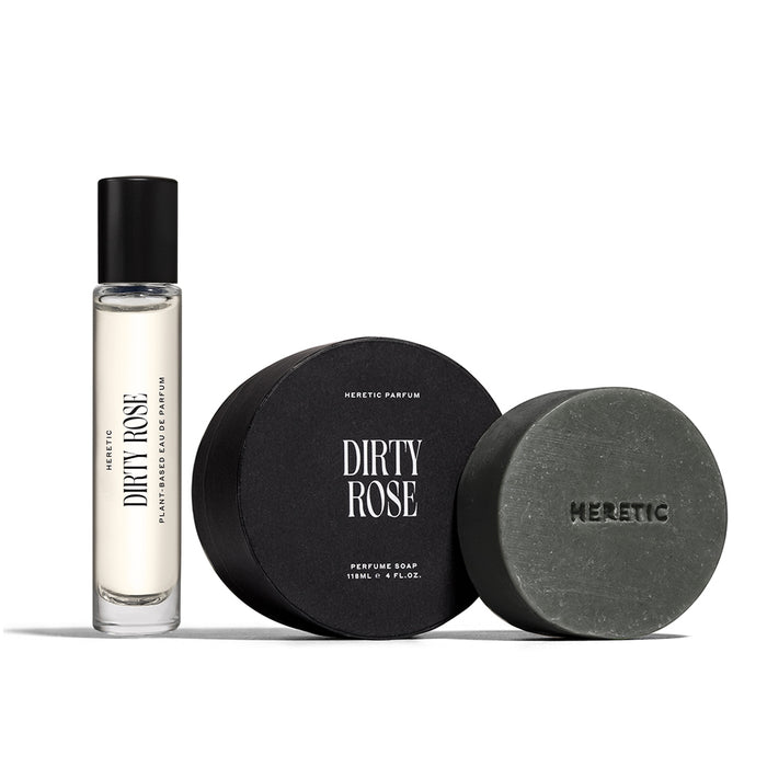Dirty Rose 15ml perfume next to the circular Dirty Rose bar soap and its box. Placed on a white background.