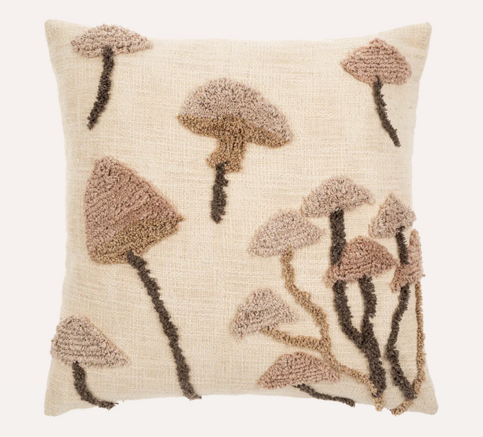 Decorative pillow with tufted mushroom pattern on a beige background