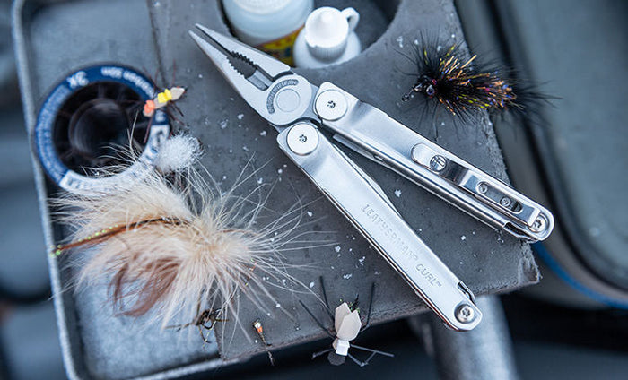 Opened Leatherman Curl on top of gray tray
