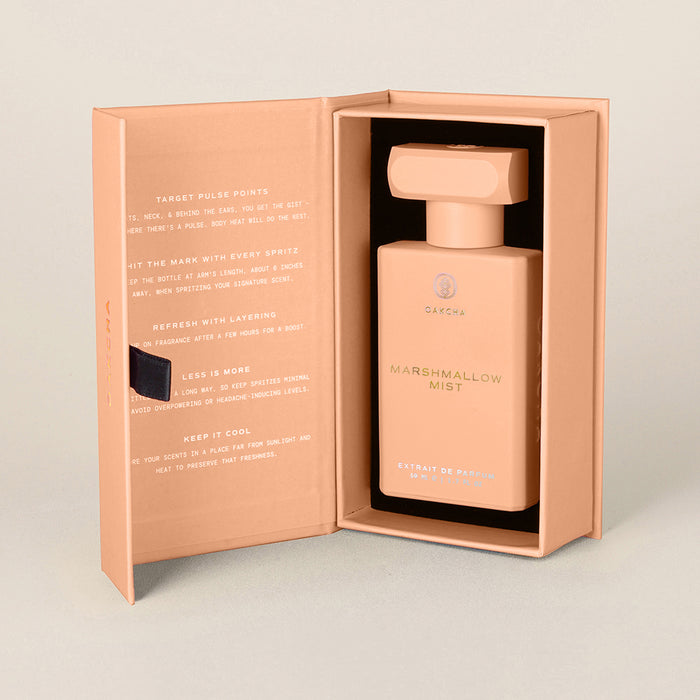 Front view of Marshmallow Mist bottle in peach pink gift box showing rectangular bottle and stopper on neutral background