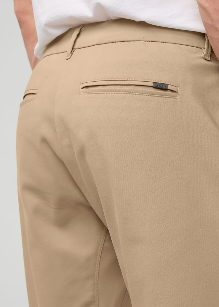 Desert khaki relaxed taper trouser with front pockets and belt loops, worn with white shirt.