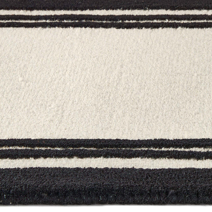Close up of Piper Monochrome Wool Runner showing pile height and  black two border design.